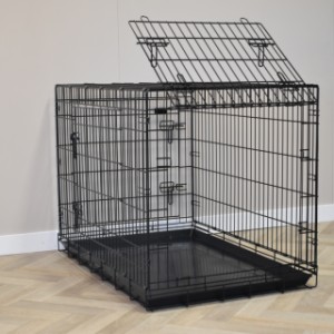 La cage pour chien XL possède une trappe sur le côté court